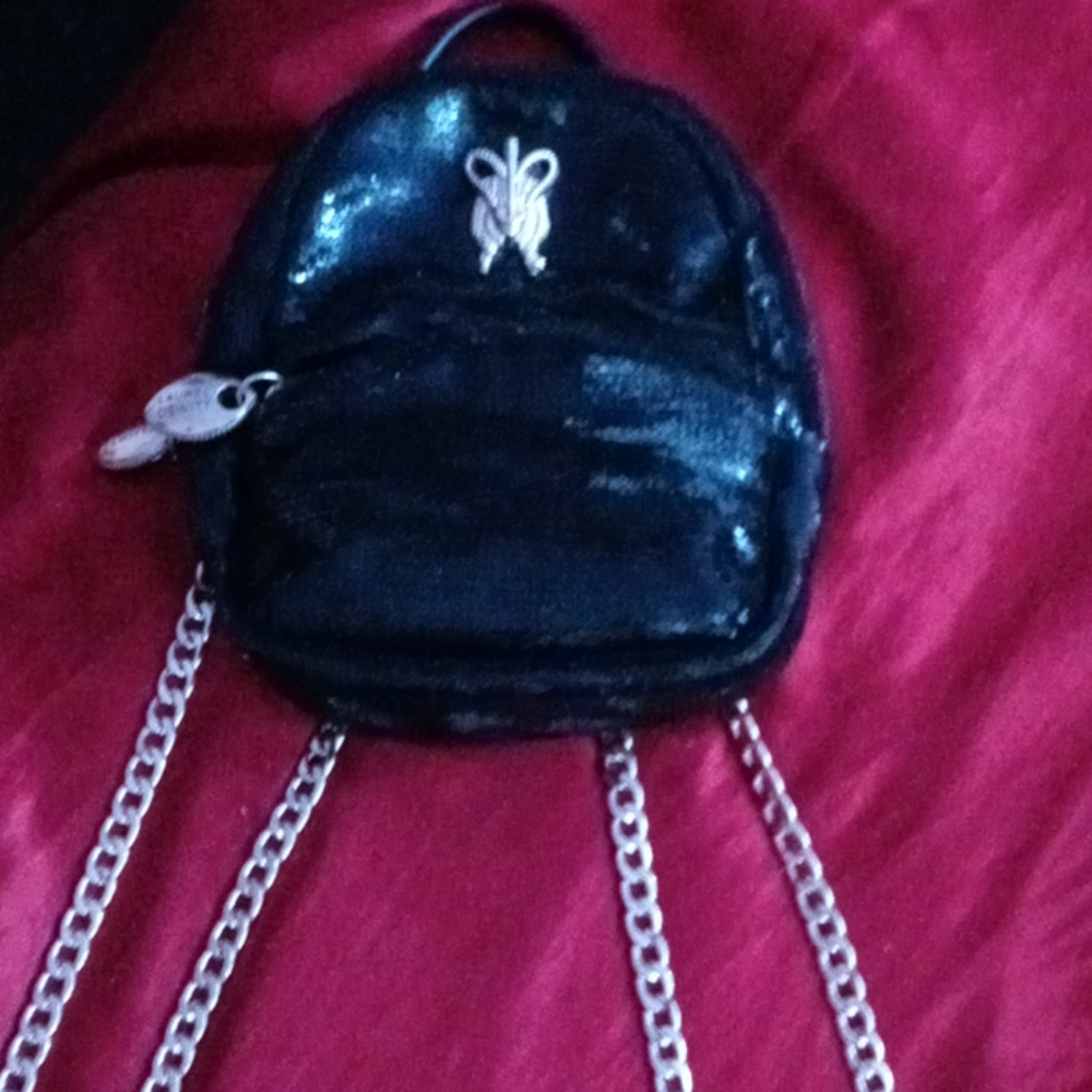 This is a mini backpack purse and is name brand plus an extra purse